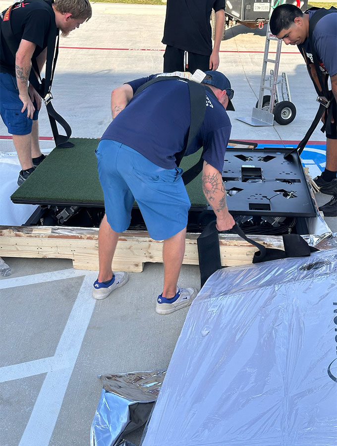 Workers upack the simulator